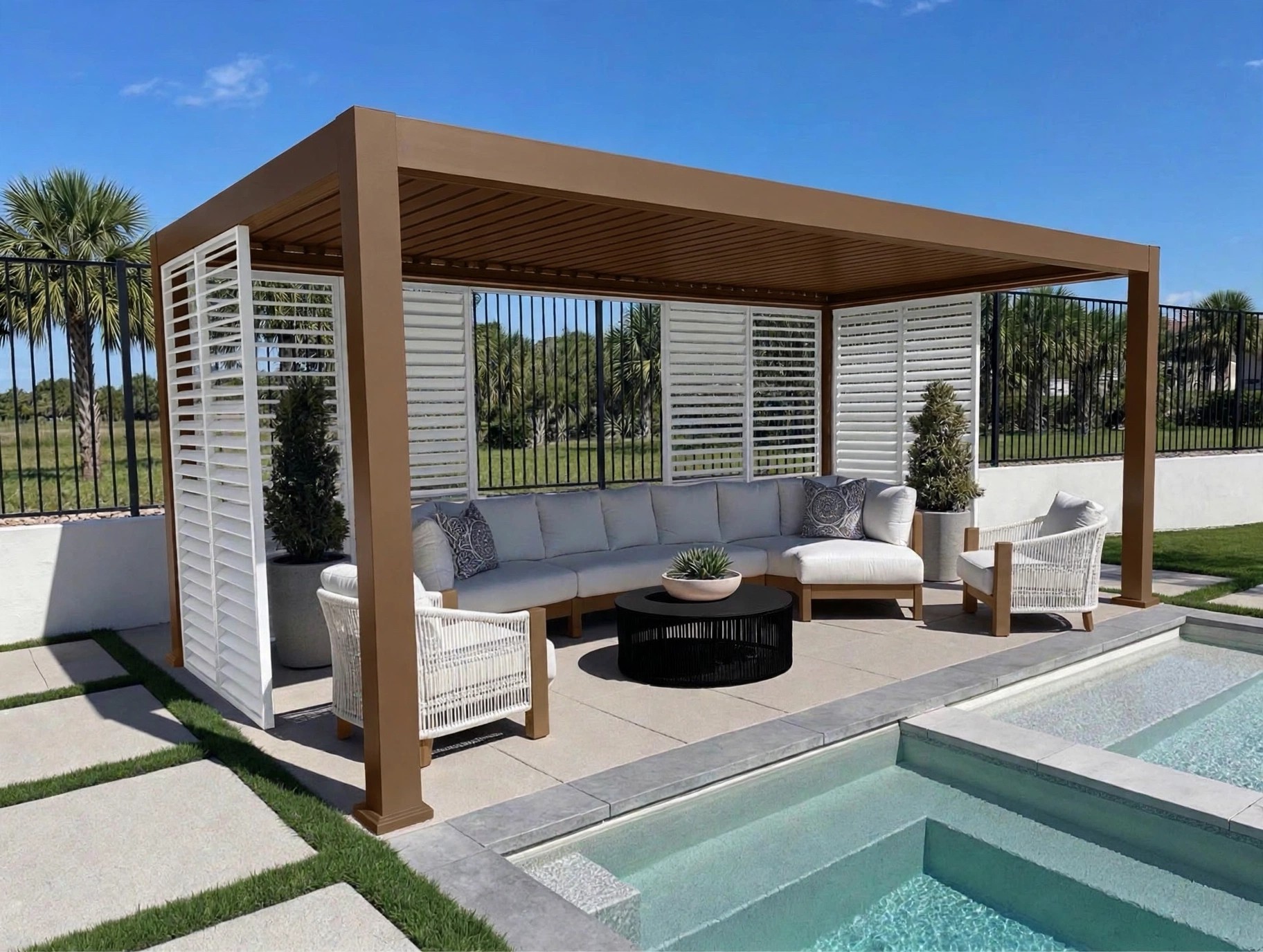 Finished custom pergola in a bronze-gold frame with white shutter walls beside a pool, seen at an angle
