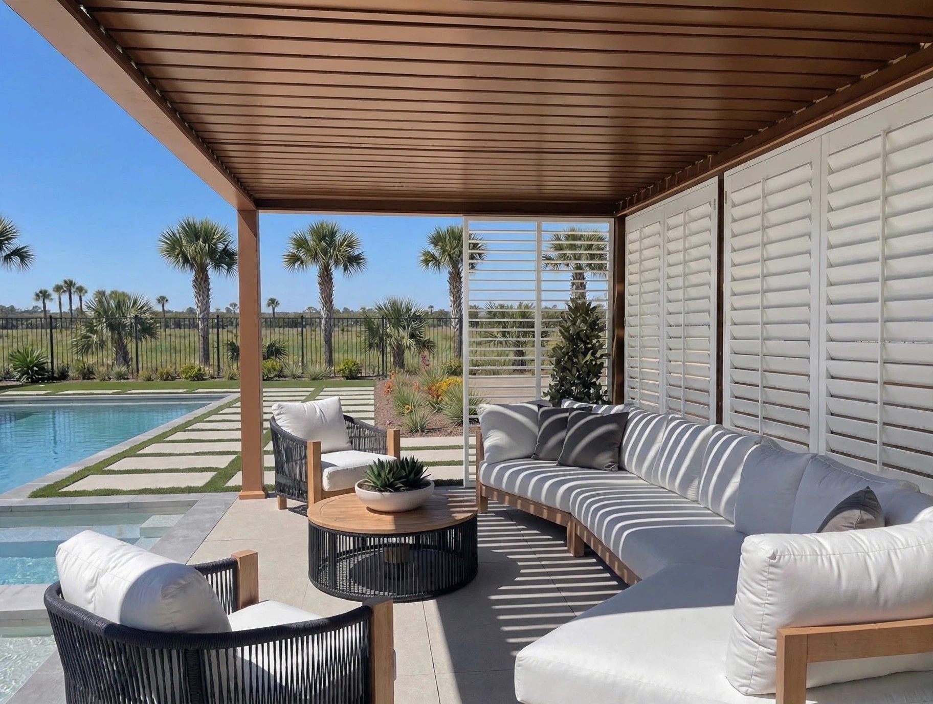Inside a finished poolside custom build, white shutter walls and striped light