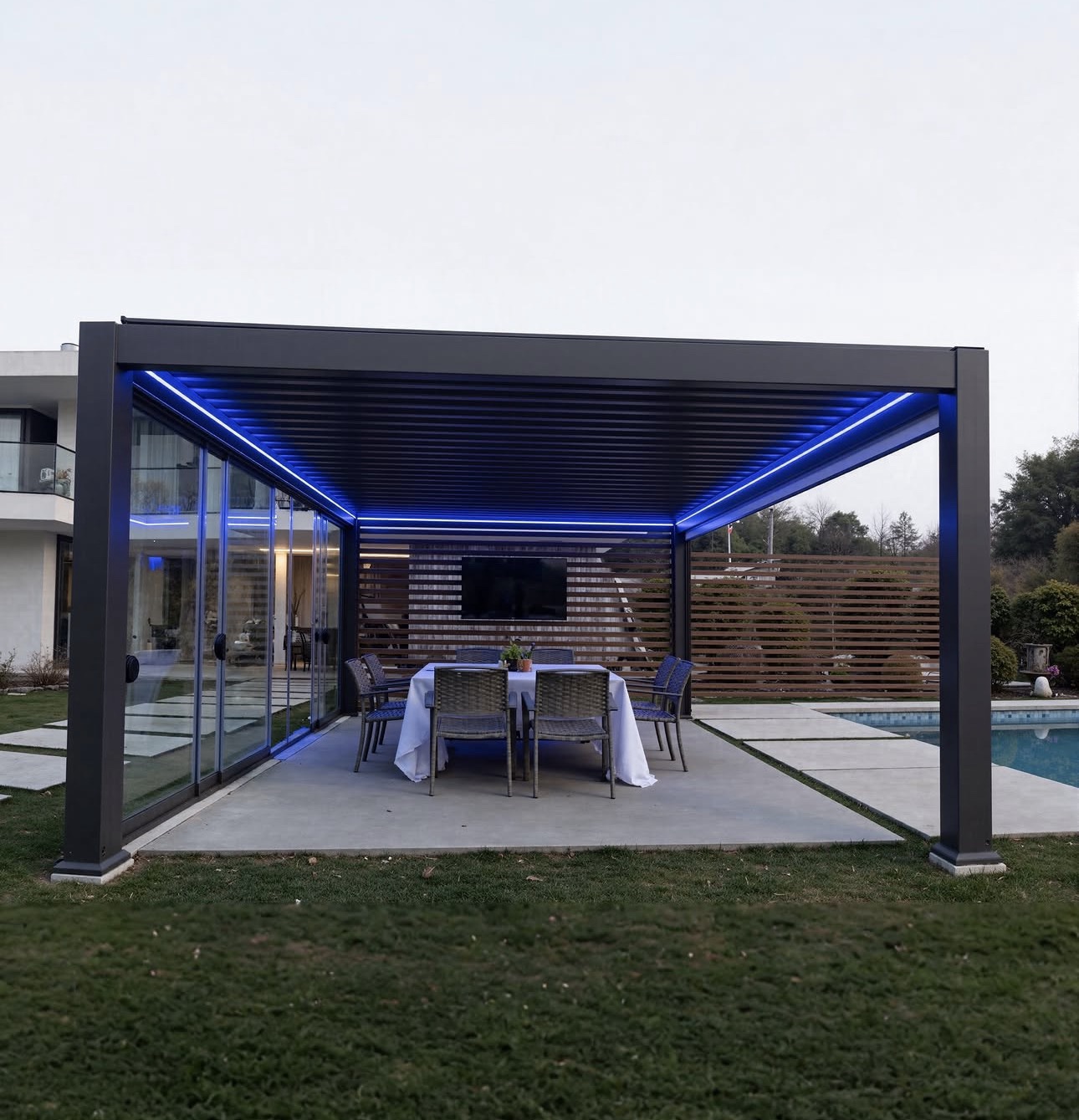 Dark charcoal motorized pergola with glass walls, a slat wall, and LED lighting over a dining patio beside a pool in Dr. Phillips.