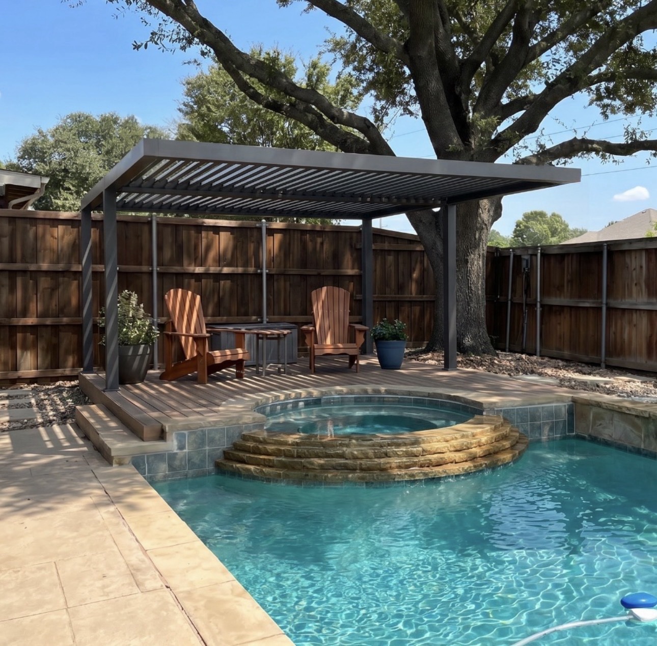 Dark charcoal motorized pergola over a pool and raised spa in Clermont.