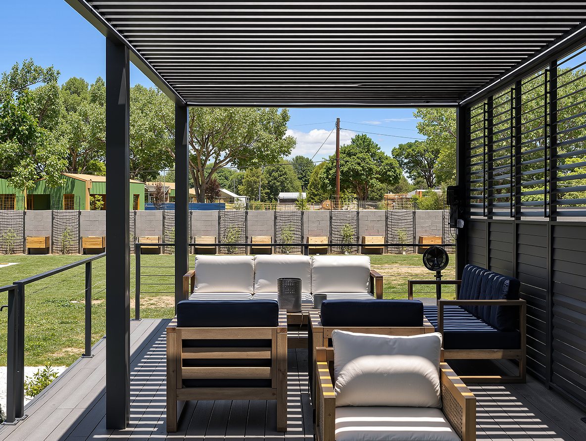 Long custom pergola run with slat walls, seen from inside