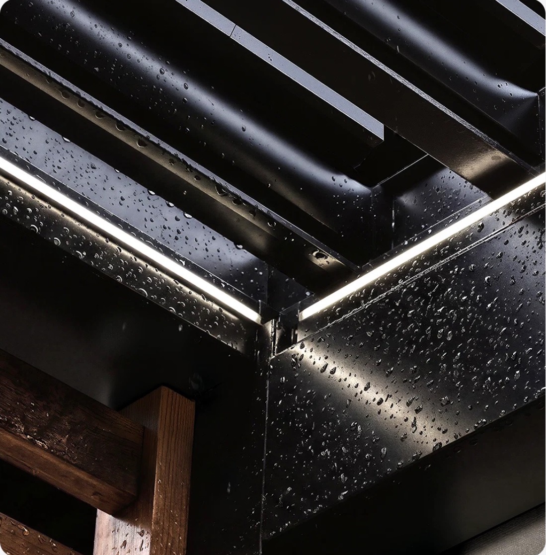 Rain beading on the Skyy+ aluminum frame next to a lit LED strip